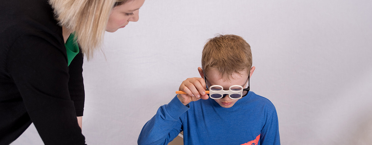boy and an eye doctor in a vision therapy session